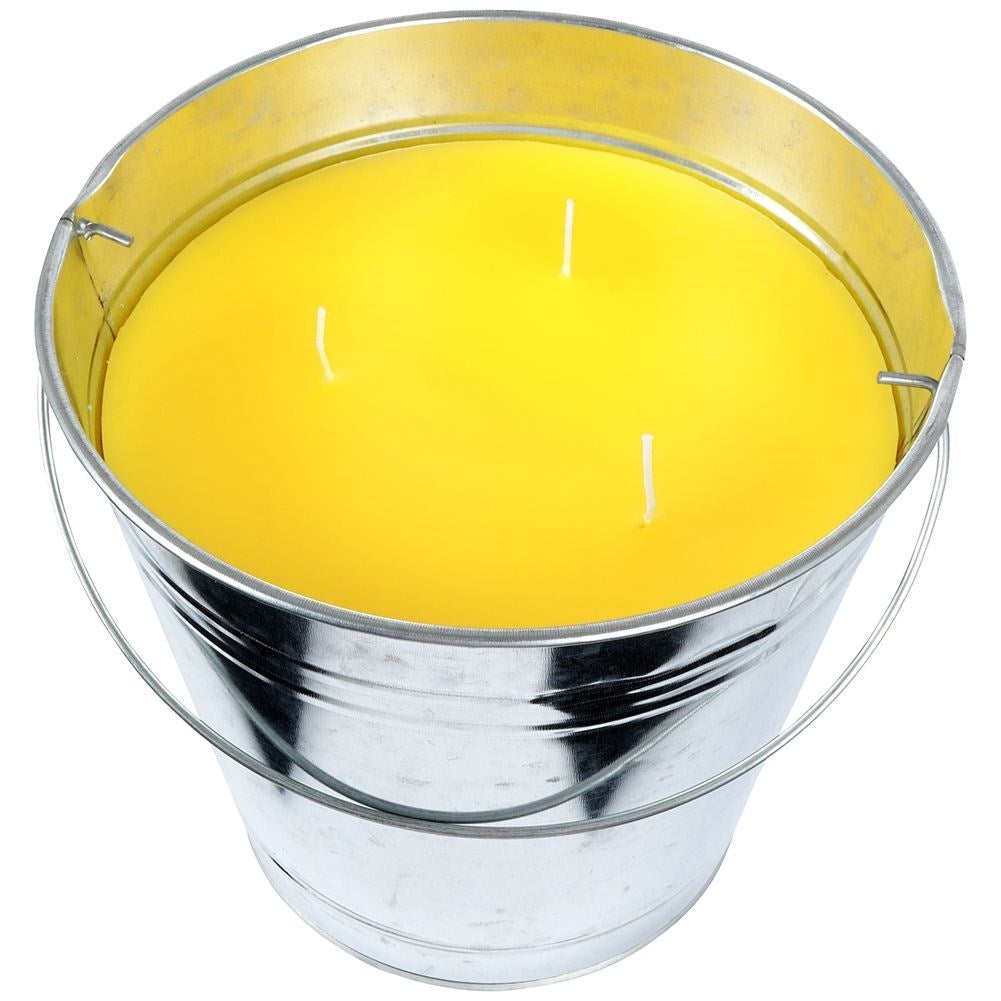 Scented candle with lemon scent and essential oil in a metal bucket