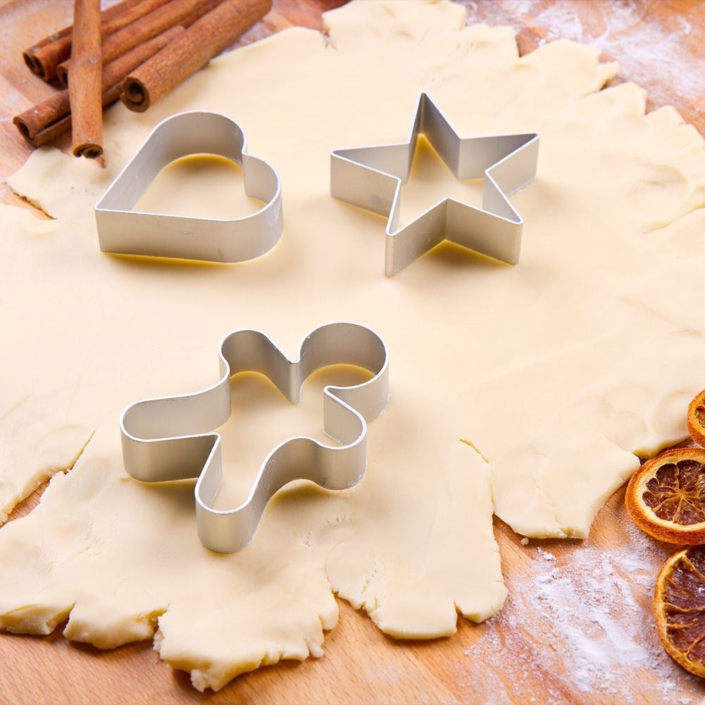 Set of 16 stainless steel Christmas cookie tins with storage