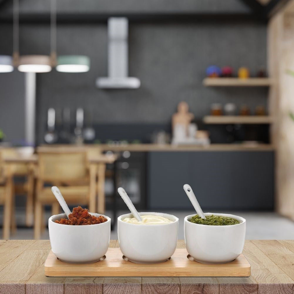 Set of 3 ceramic bowls on bamboo tray with spoons for serving
