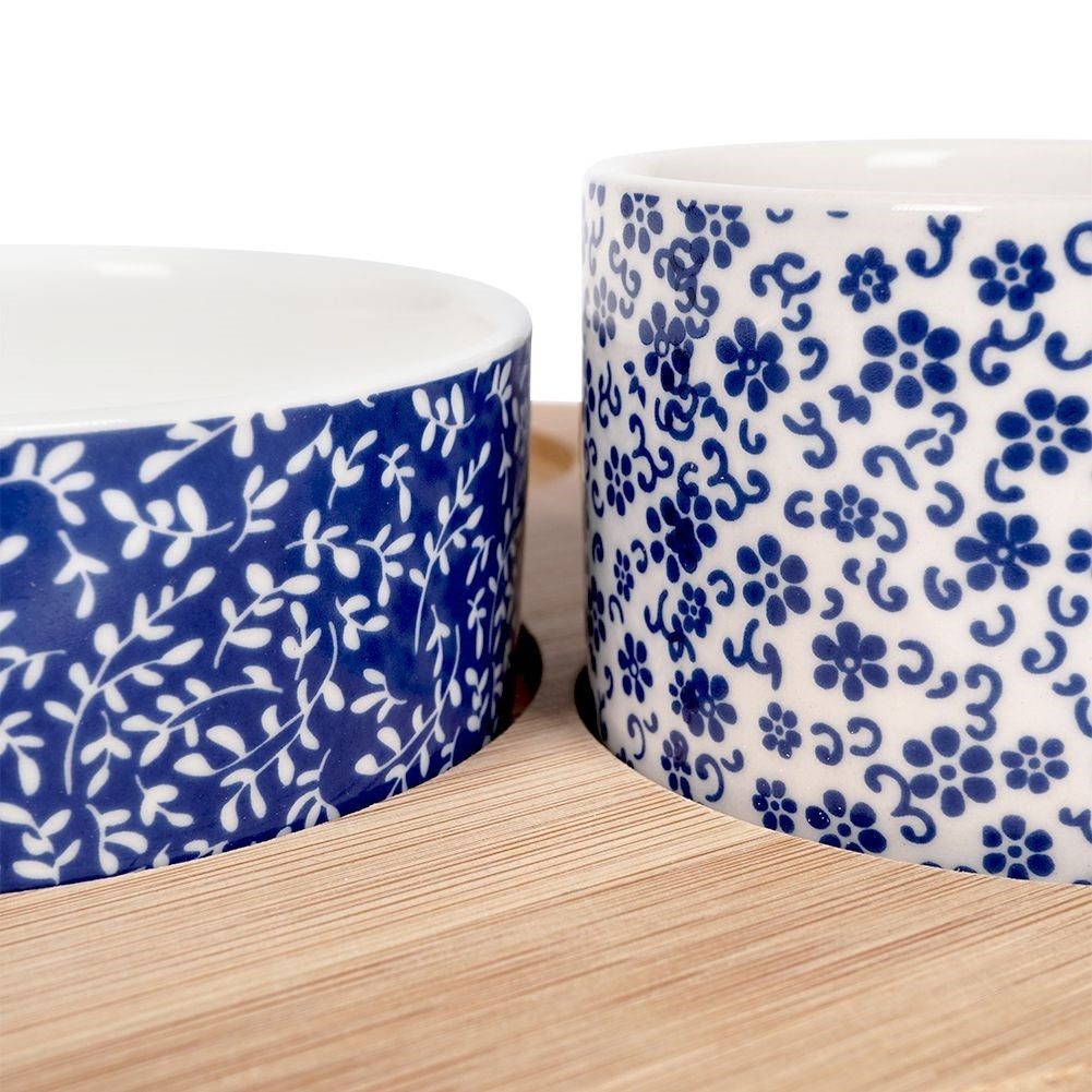 Set of 4 porcelain bowls on bamboo tray for serving