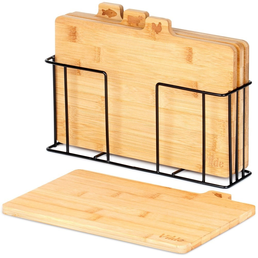 Set of bamboo cutting boards in a metal stand with a unique design