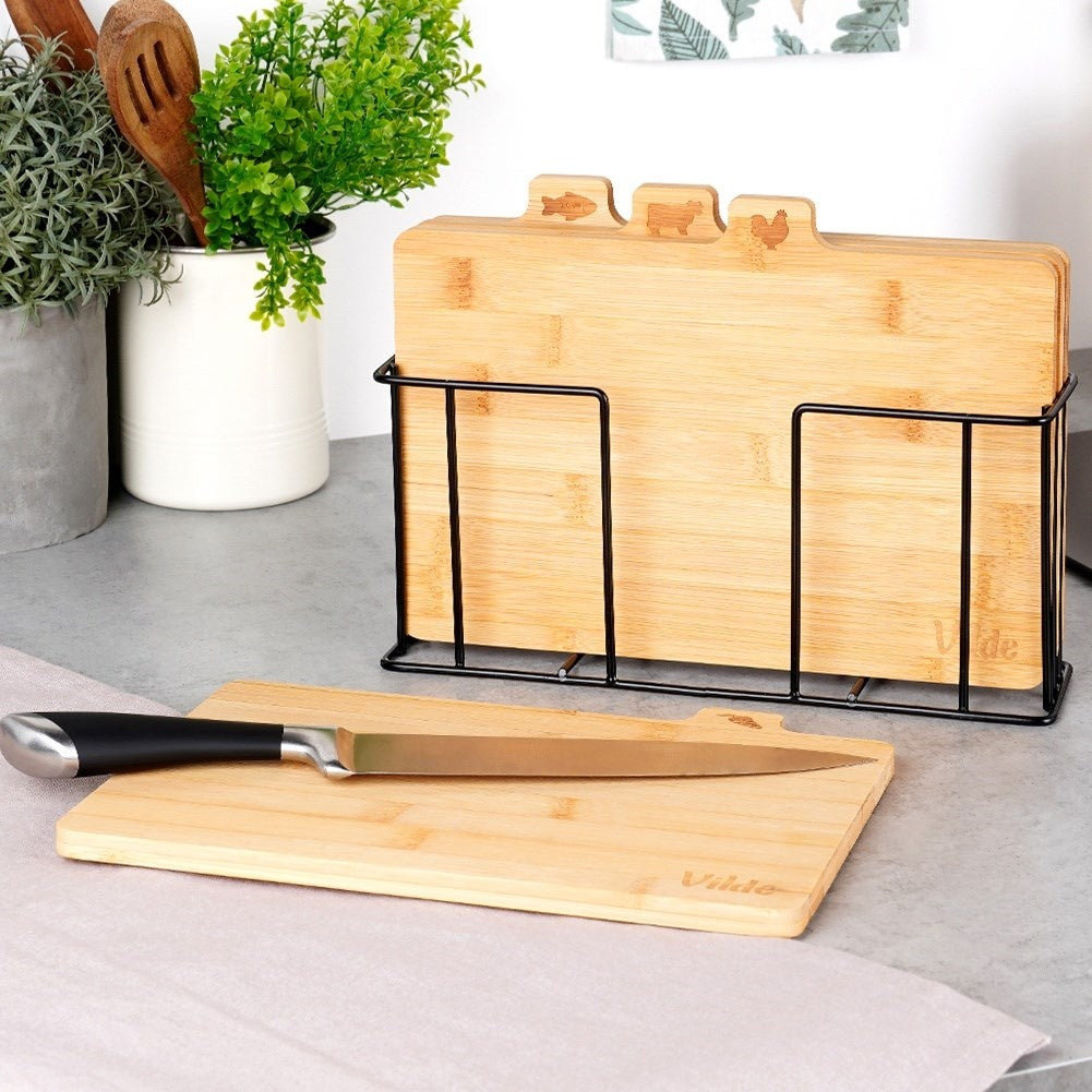 Set of bamboo cutting boards in a metal stand with a unique design