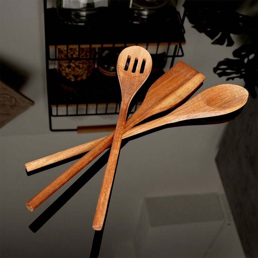 Set of kitchen utensils in acacia wood: all-round spoon, slotted spoon, universal spoon