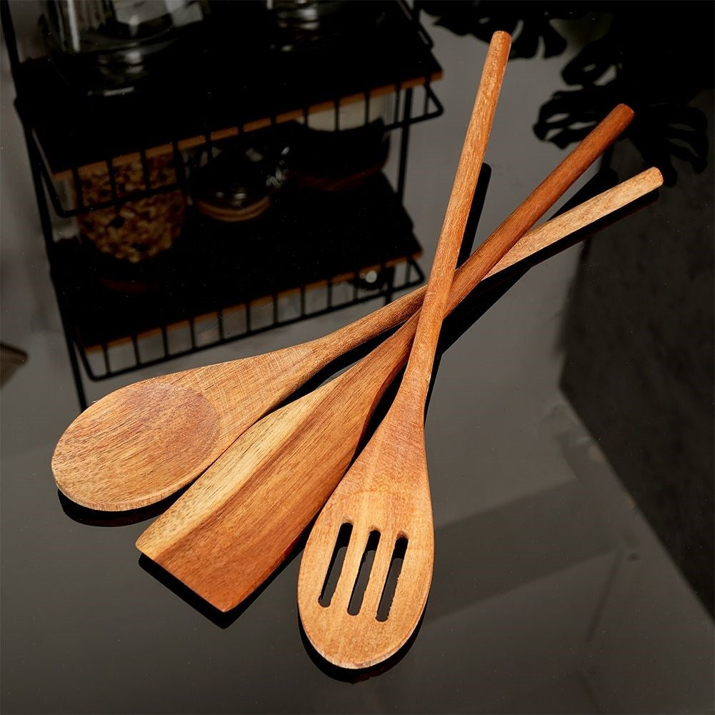 Set of kitchen utensils in acacia wood: all-round spoon, slotted spoon, universal spoon
