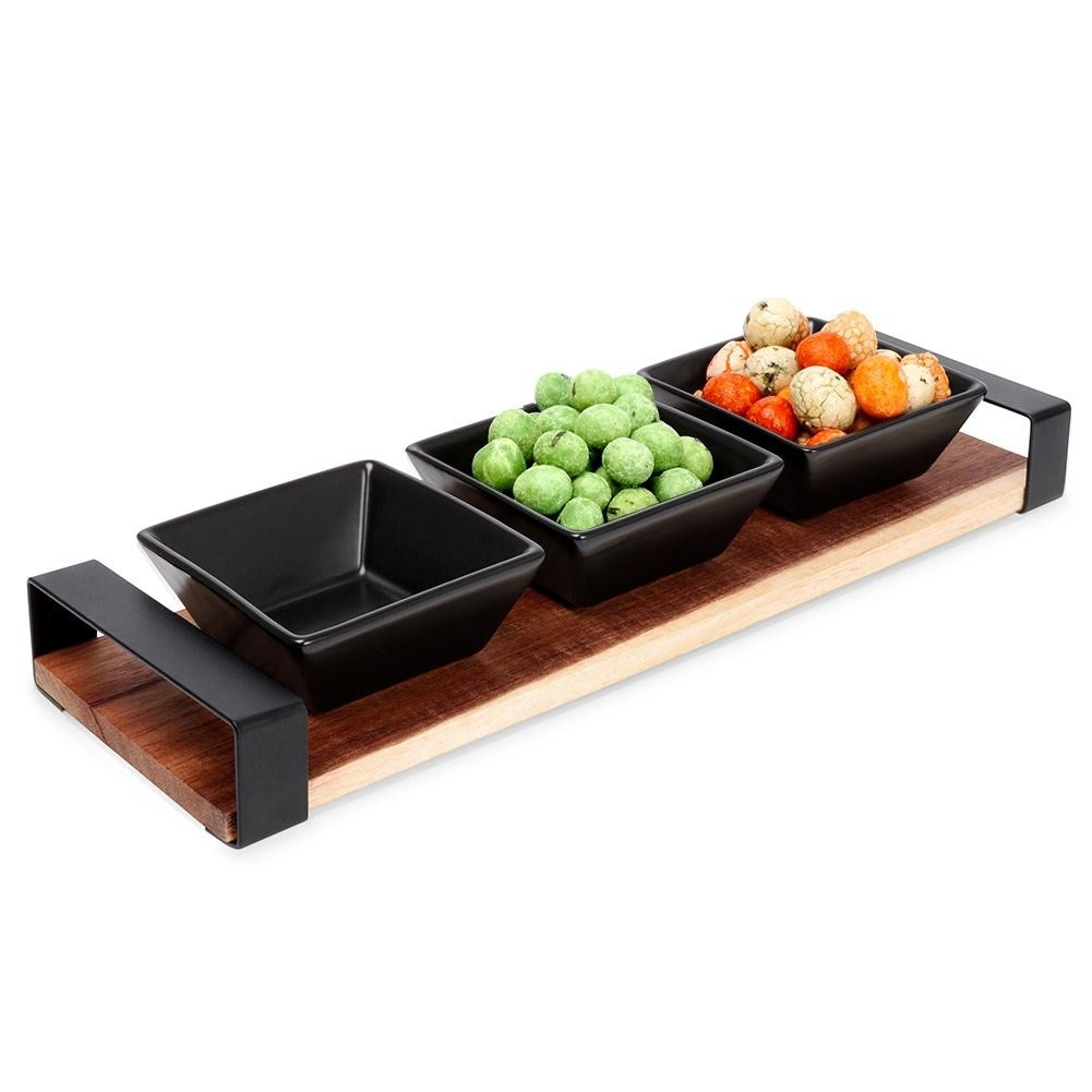 Set of three bowls on acacia tray for snacks and sauces