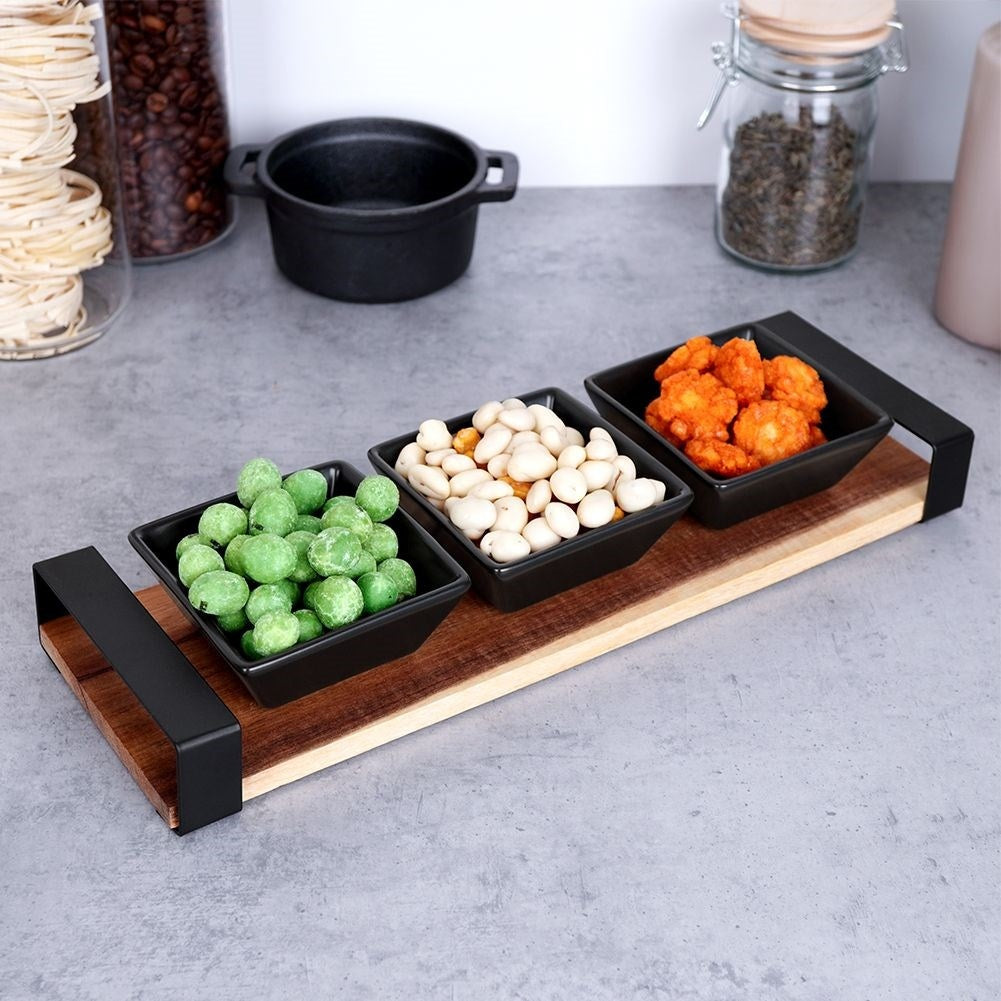 Set of three bowls on acacia tray for snacks and sauces