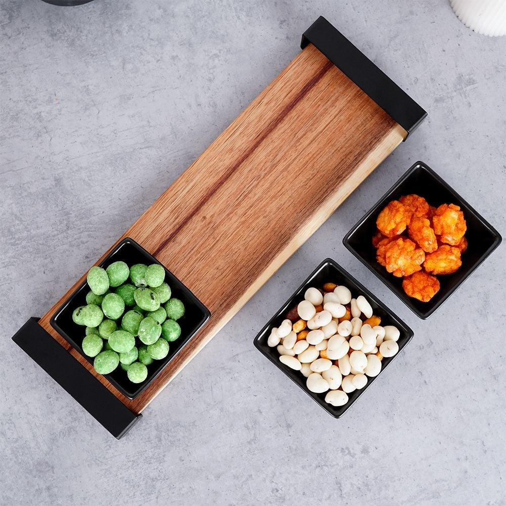 Set of three bowls on acacia tray for snacks and sauces