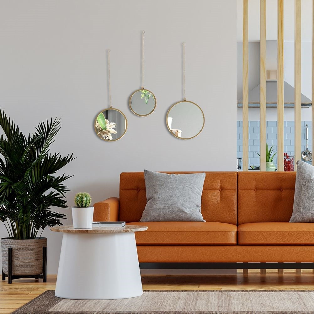 Set of three elegant wall mirrors with golden frames