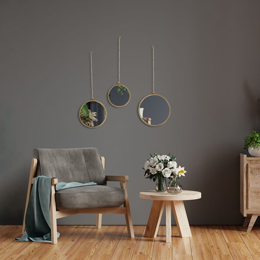 Set of three elegant wall mirrors with golden frames