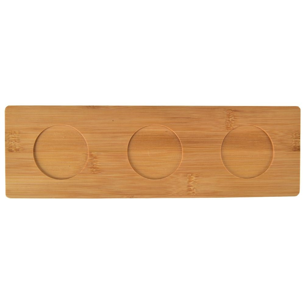 Set of three porcelain bowls and spoons on a bamboo tray