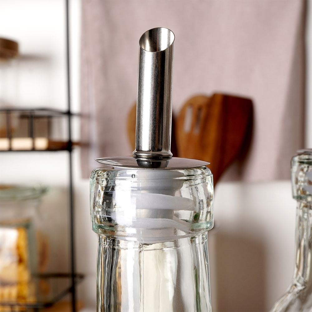 Set of two glass bottles with dispenser and stand in stainless steel