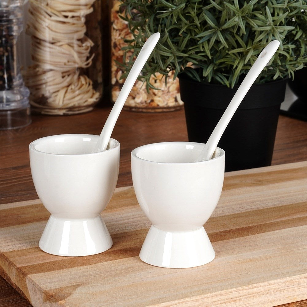 Set of two white porcelain egg cups with spoons
