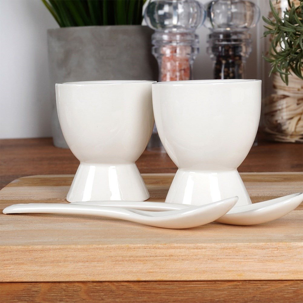 Set of two white porcelain egg cups with spoons
