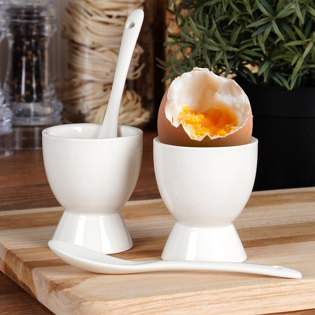 Set of two white porcelain egg cups with spoons