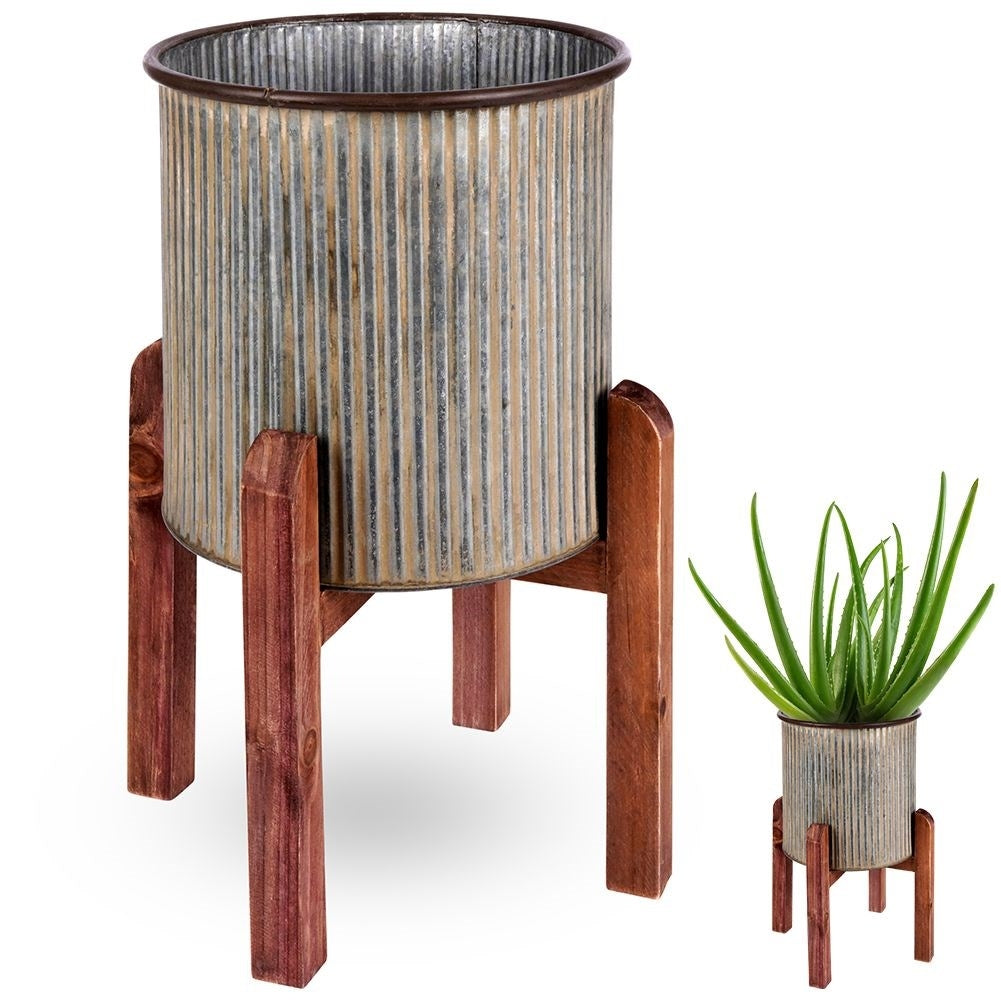 Silver colored fluted flower pot on a wooden stand