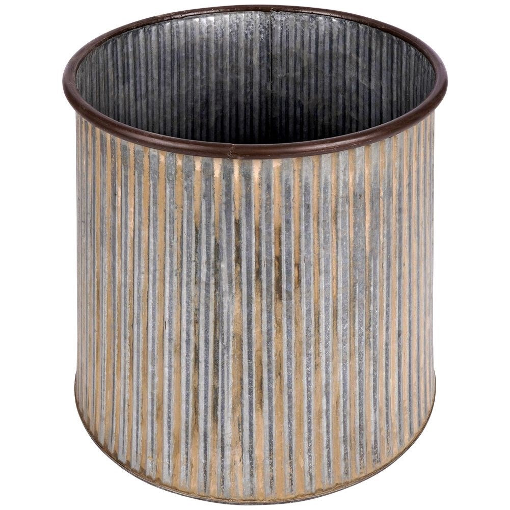 Silver colored fluted flower pot on a wooden stand