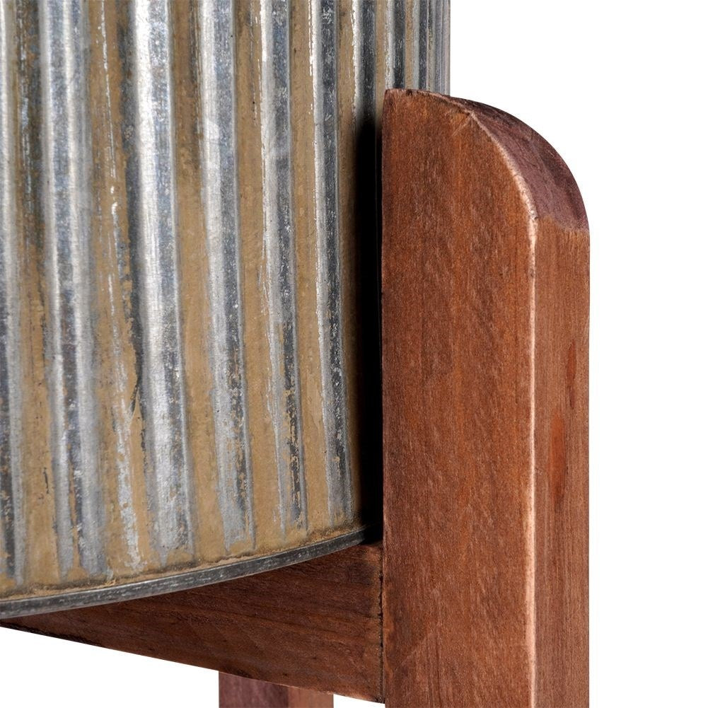 Silver colored fluted flower pot on a wooden stand