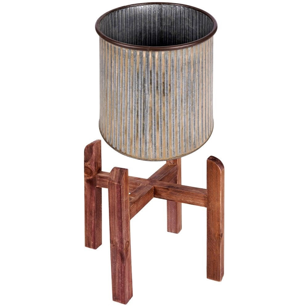 Silver colored fluted flower pot on a wooden stand