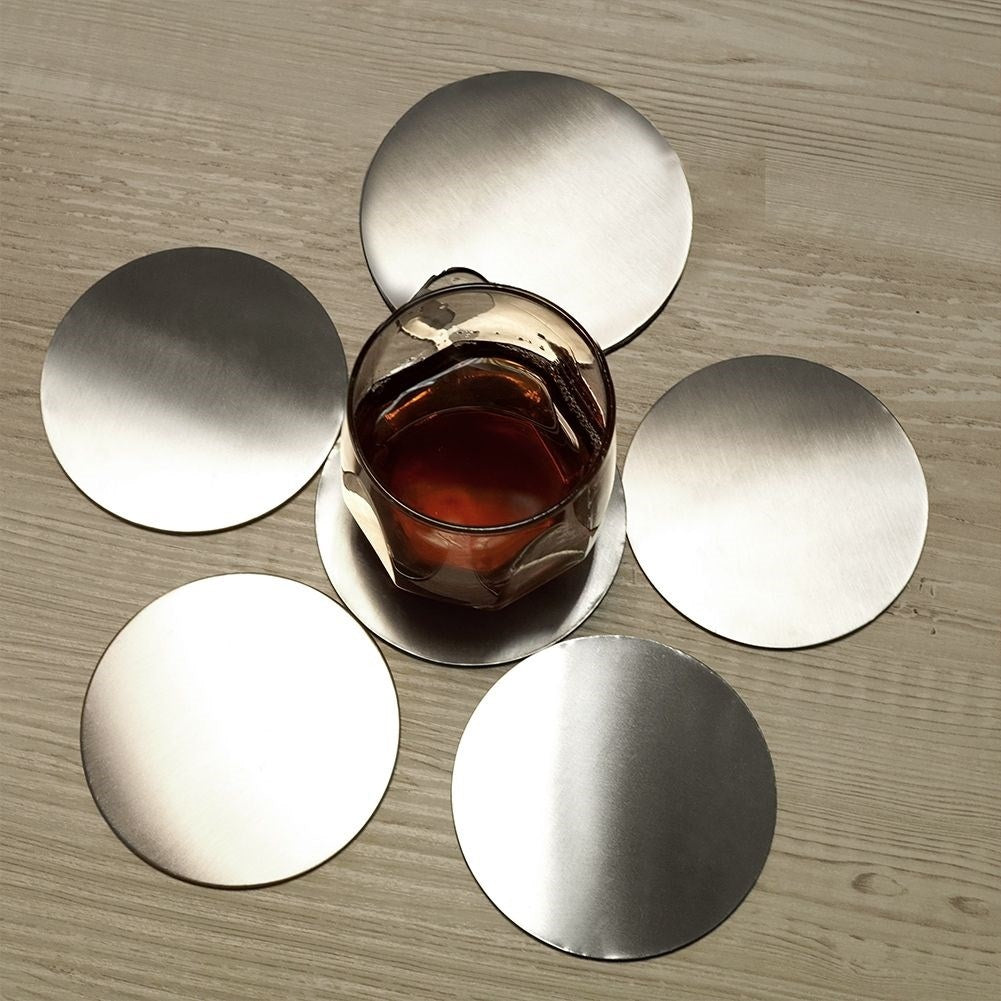 Six stainless steel coasters with protective foam