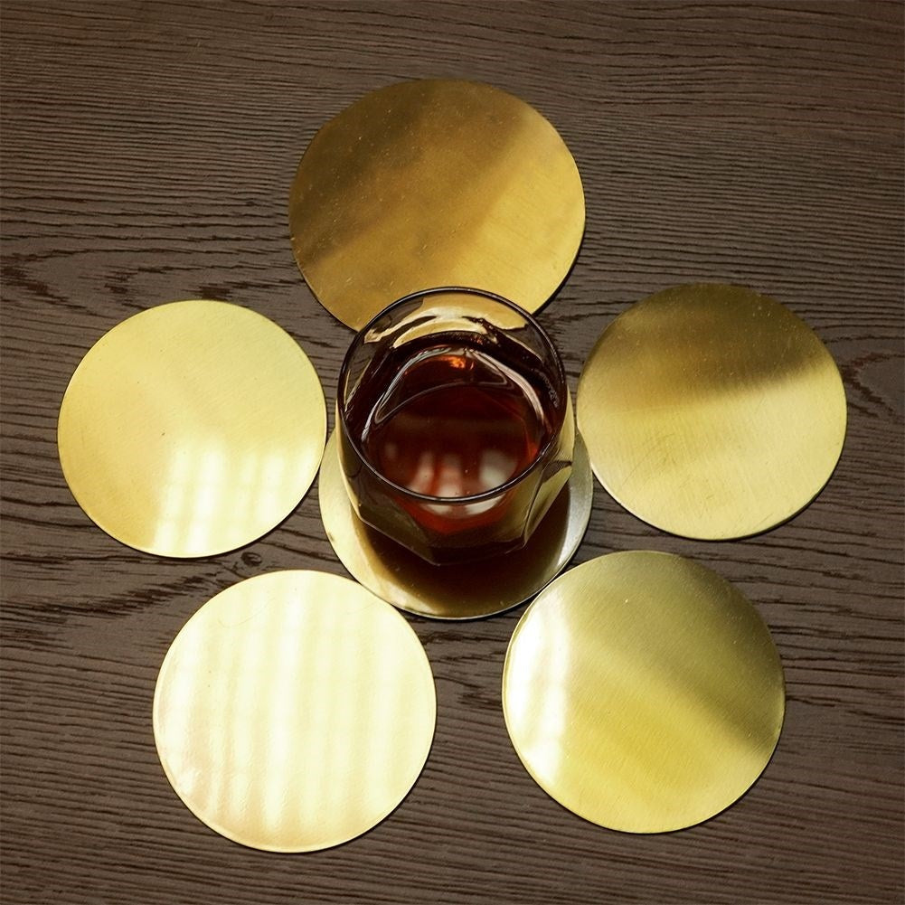 Six stylish coasters in gold-colored stainless steel with a protective layer