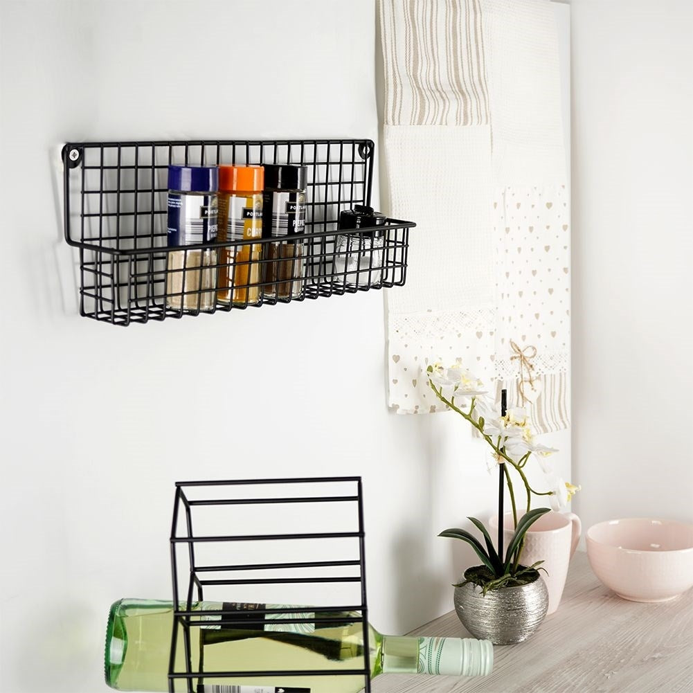 Slim wall-mounted shelf in black metal for spices and cosmetics