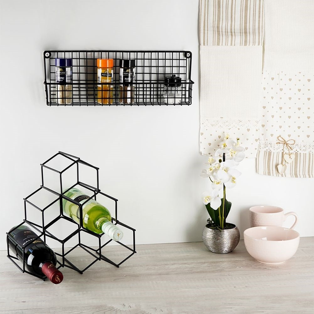 Slim wall-mounted shelf in black metal for spices and cosmetics