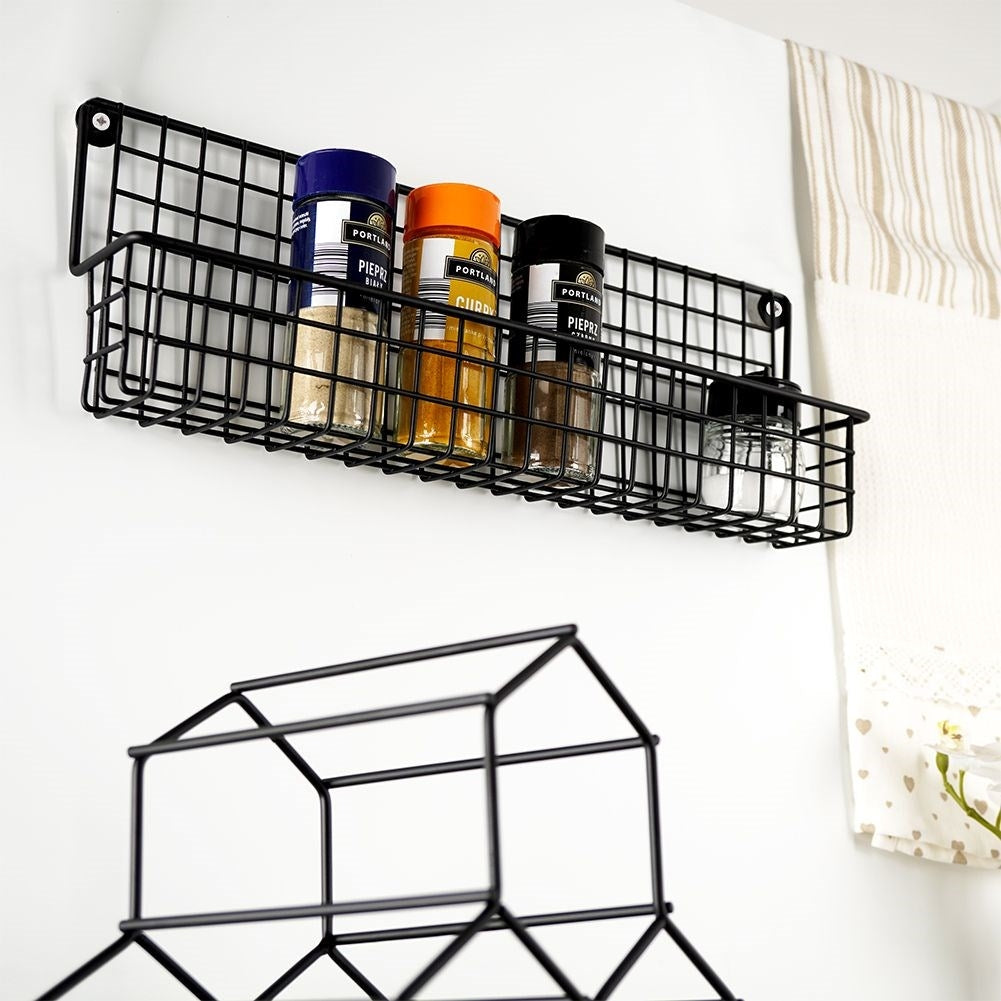 Slim wall-mounted shelf in black metal for spices and cosmetics