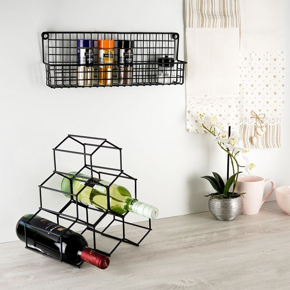 Slim wall-mounted shelf in black metal for spices and cosmetics