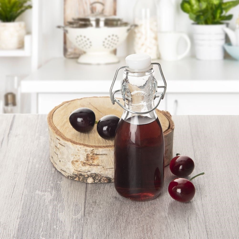 Small glass bottle 160 ml with tight-fitting clamp closure