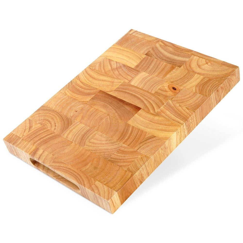 Solid wooden cutting board with recesses for easy handling