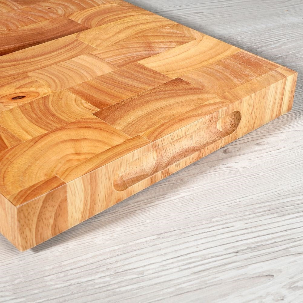 Solid wooden cutting board with recesses for easy handling