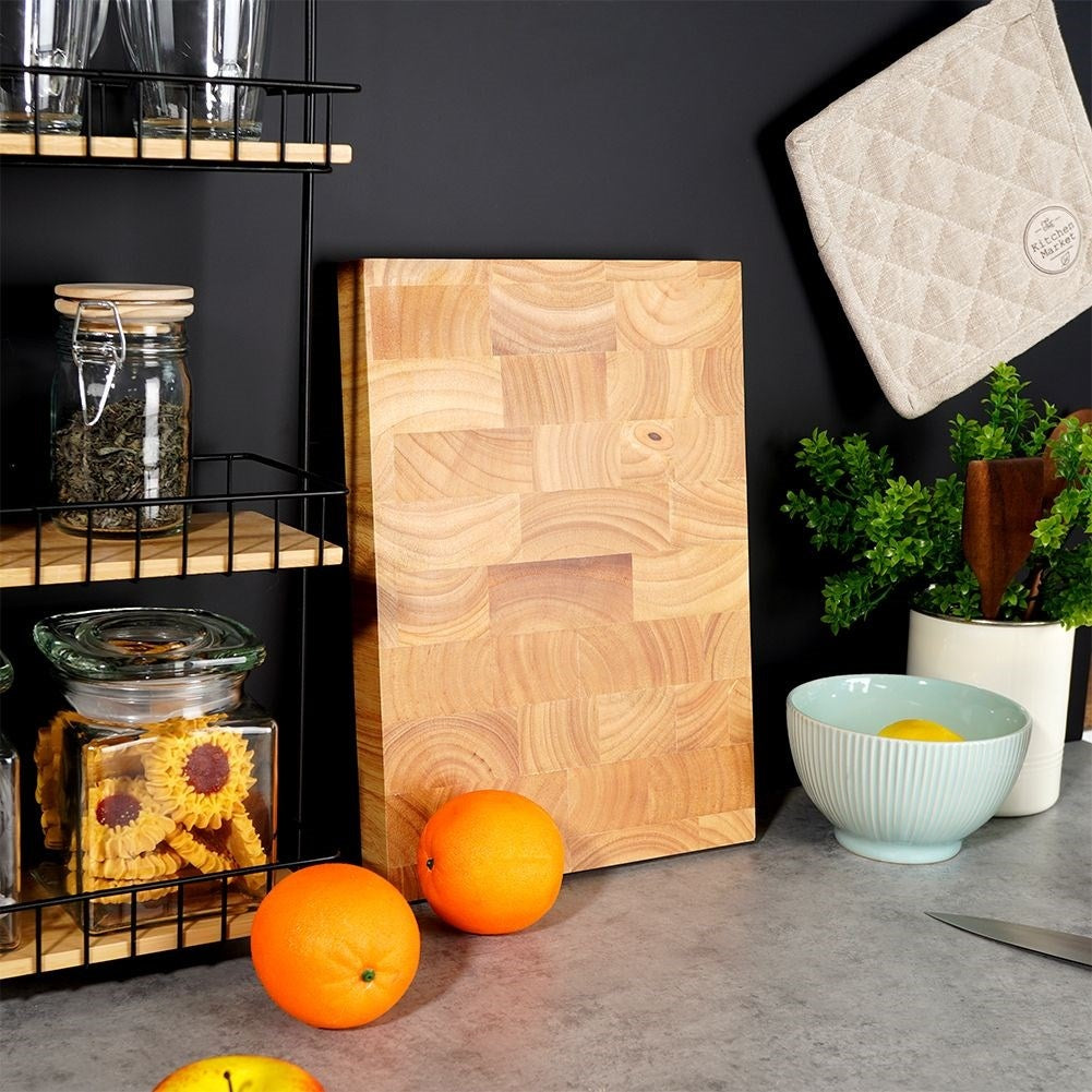 Solid wooden cutting board with recesses for easy handling