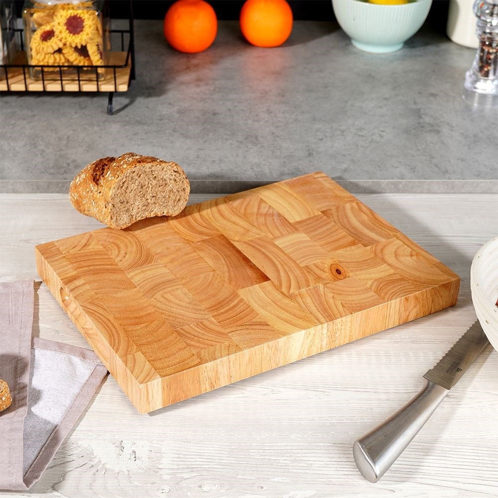 Solid wooden cutting board with recesses for easy handling
