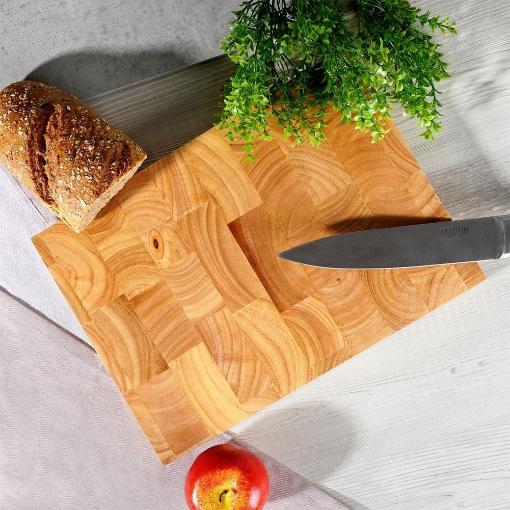 Solid wooden cutting board with recesses for easy handling