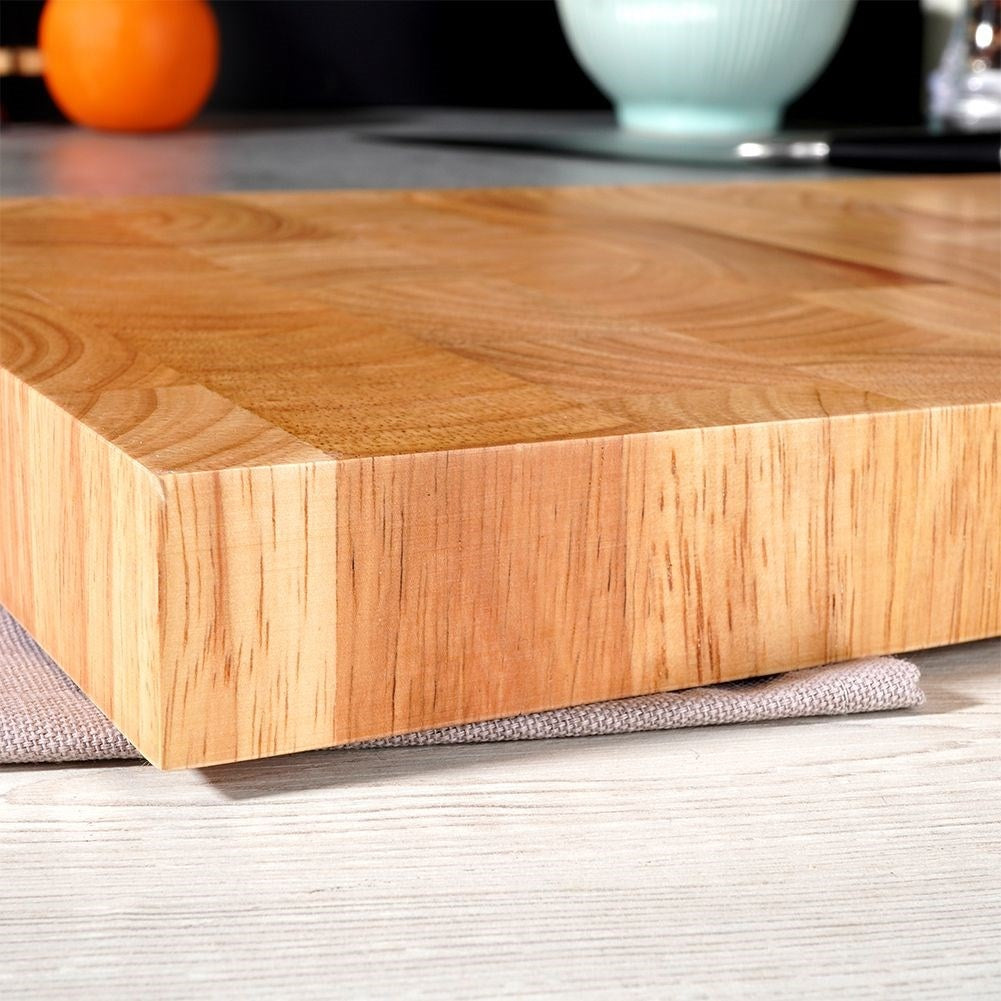 Solid wooden cutting board with recesses for easy handling