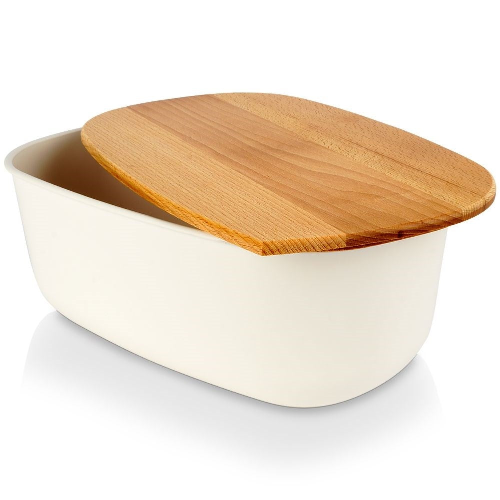 Spacious cream colored bread box with wooden cutting board