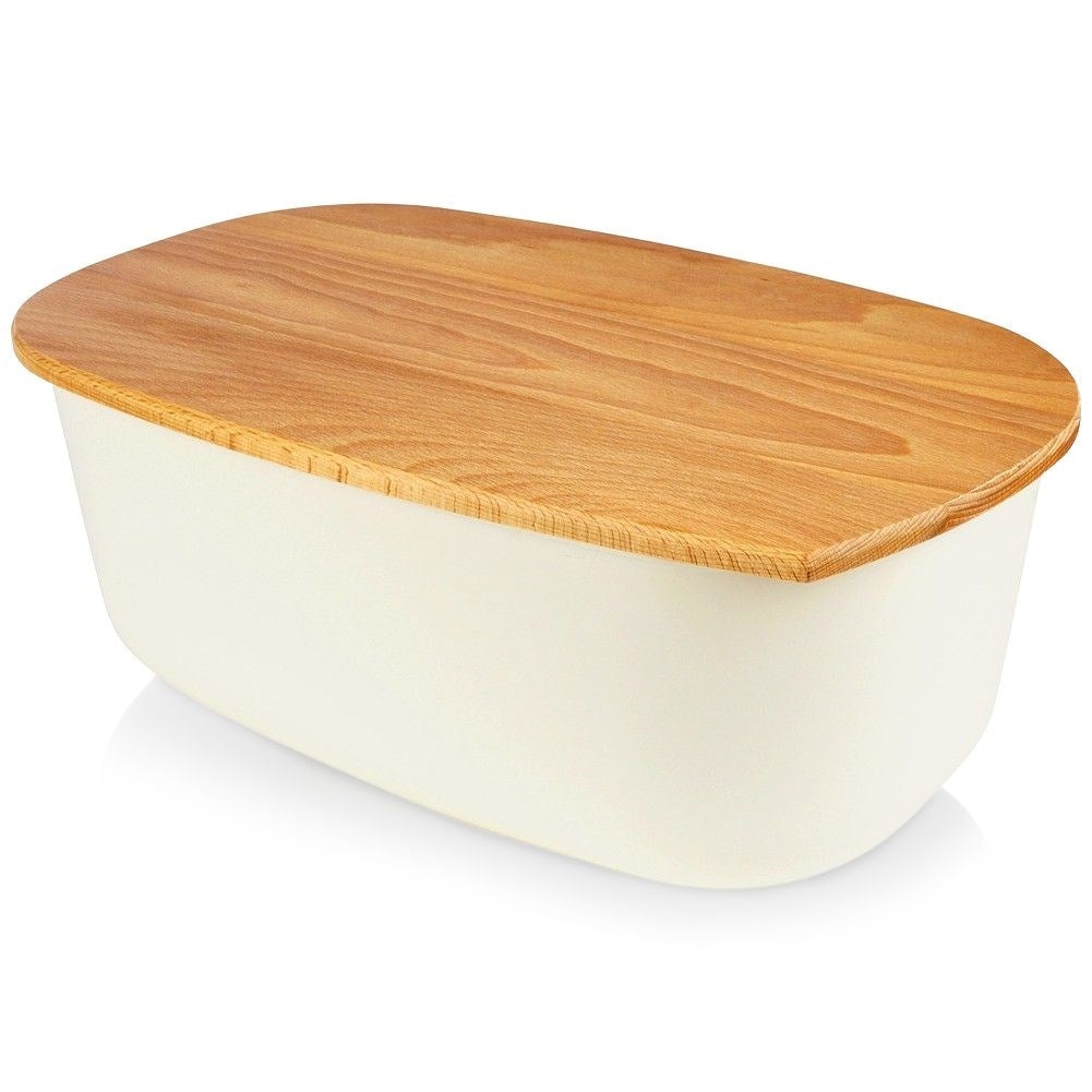 Spacious cream colored bread box with wooden cutting board