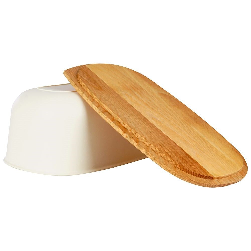 Spacious cream colored bread box with wooden cutting board