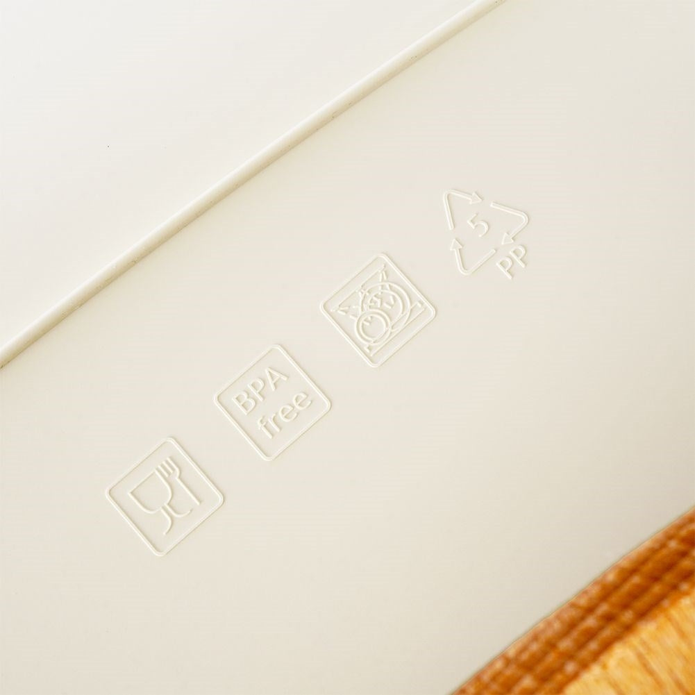 Spacious cream colored bread box with wooden cutting board