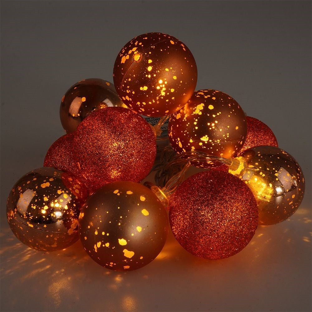 Sparkling copper colored Christmas tree balls with LED lights