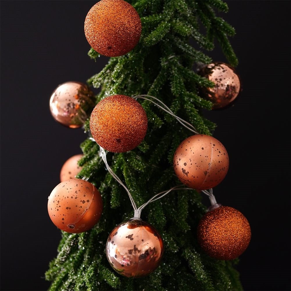 Sparkling copper colored Christmas tree balls with LED lights