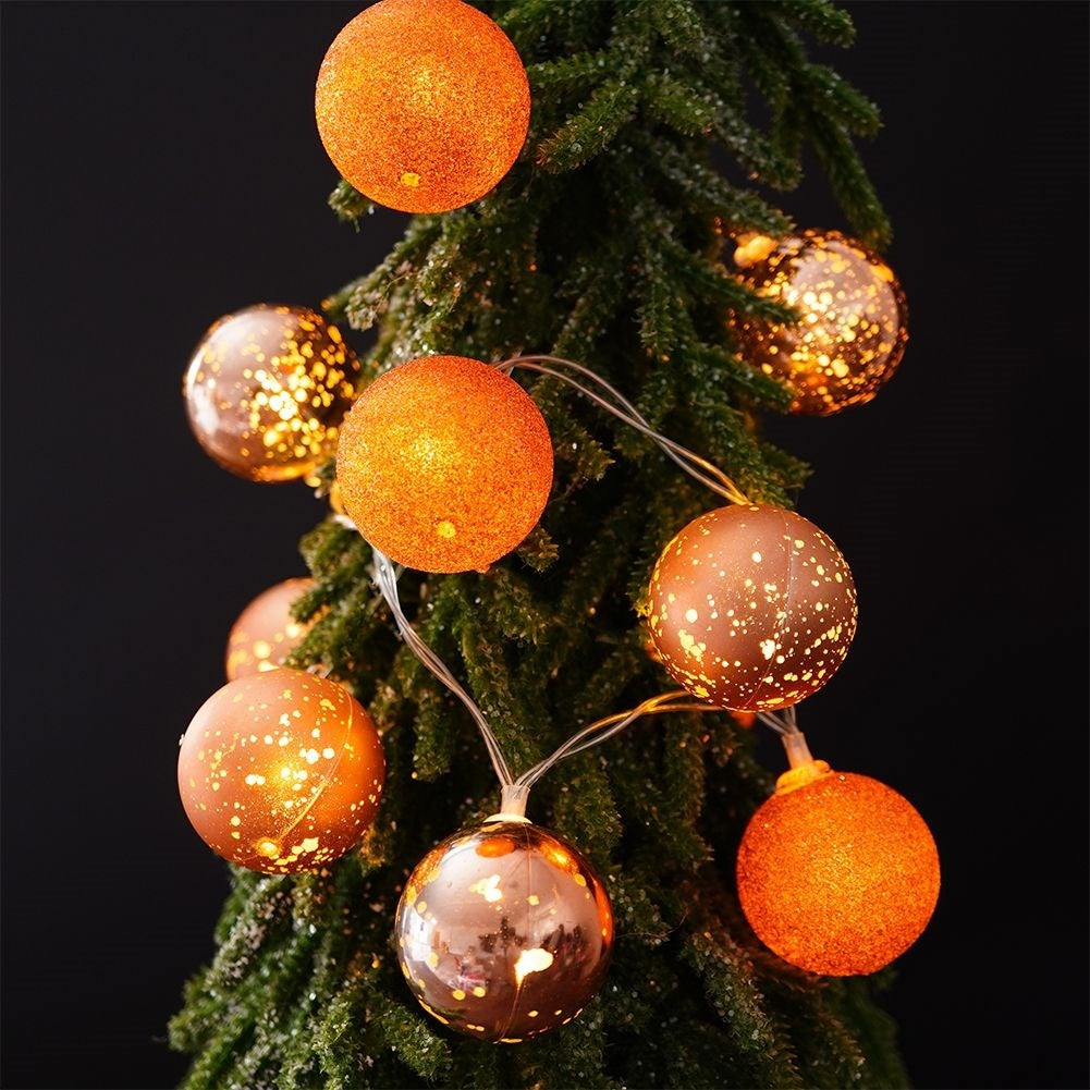 Sparkling copper colored Christmas tree balls with LED lights