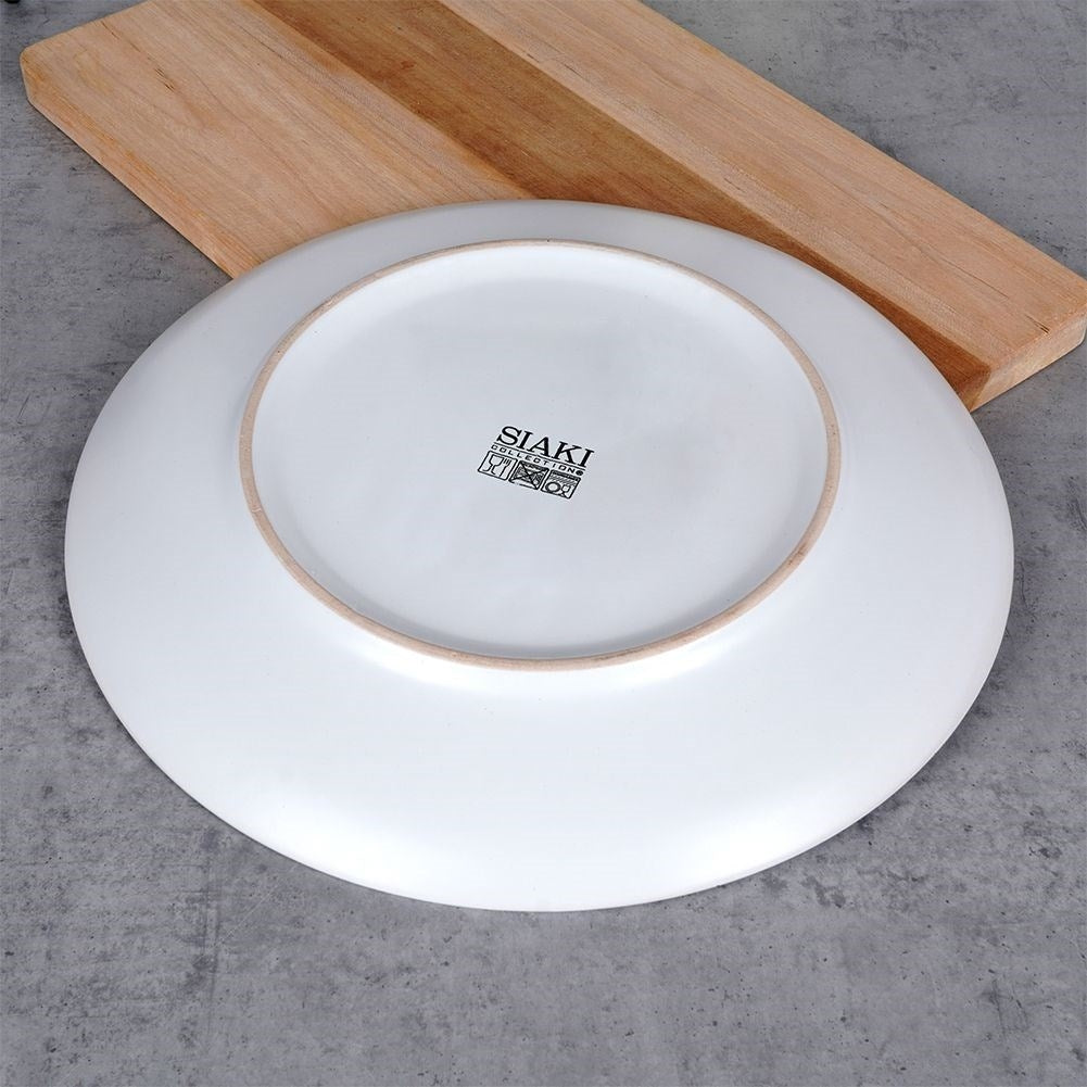 Splash-patterned matt white ceramic plate in black and gold