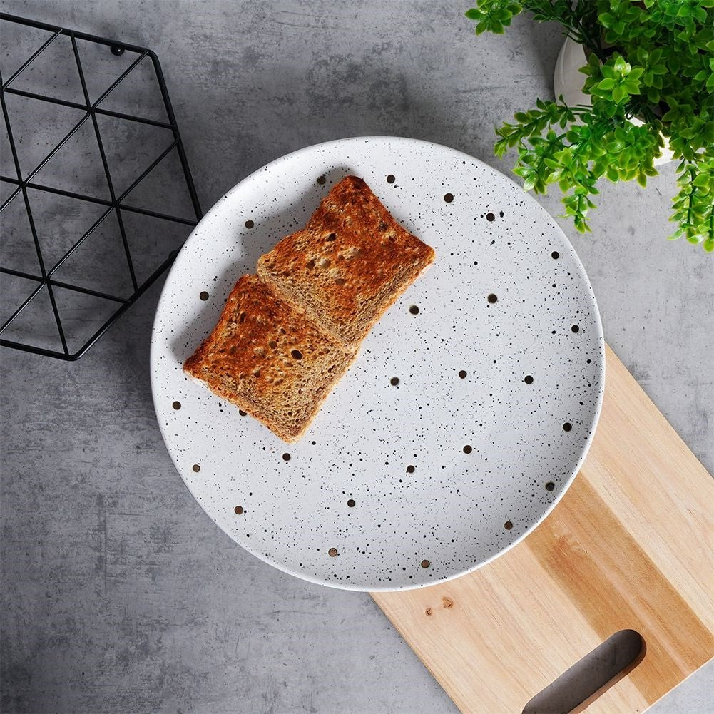 Splash-patterned matt white ceramic plate in black and gold