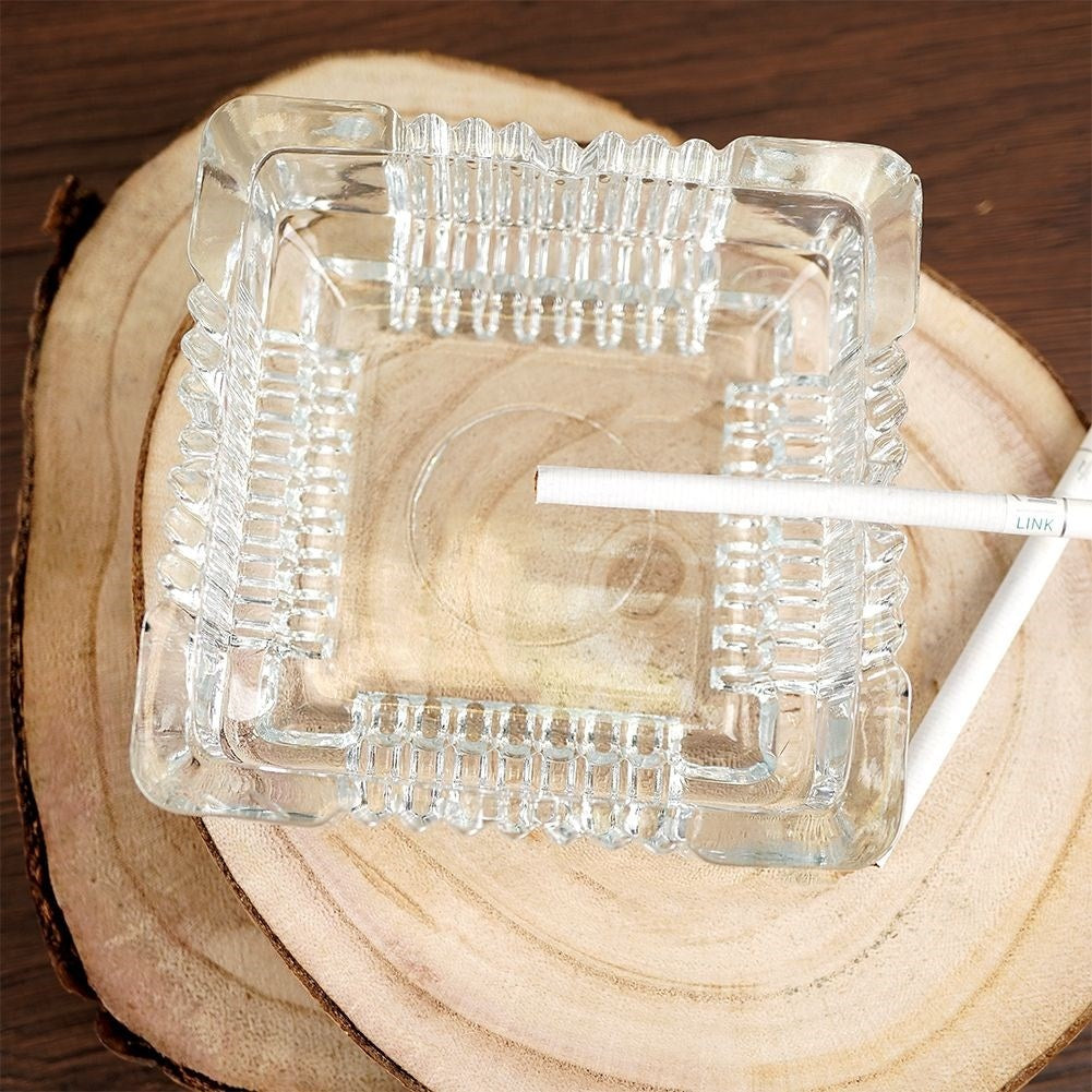 Square crystal-like glass ashtray with four cigarette sockets