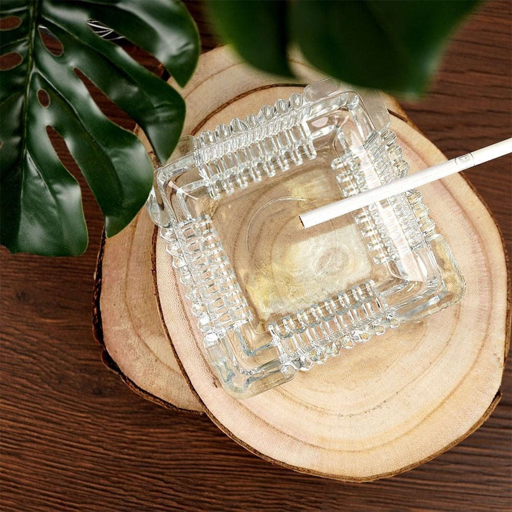 Square crystal-like glass ashtray with four cigarette sockets