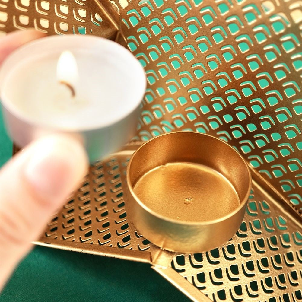 Star-shaped candle holder in gold and black for heat candles