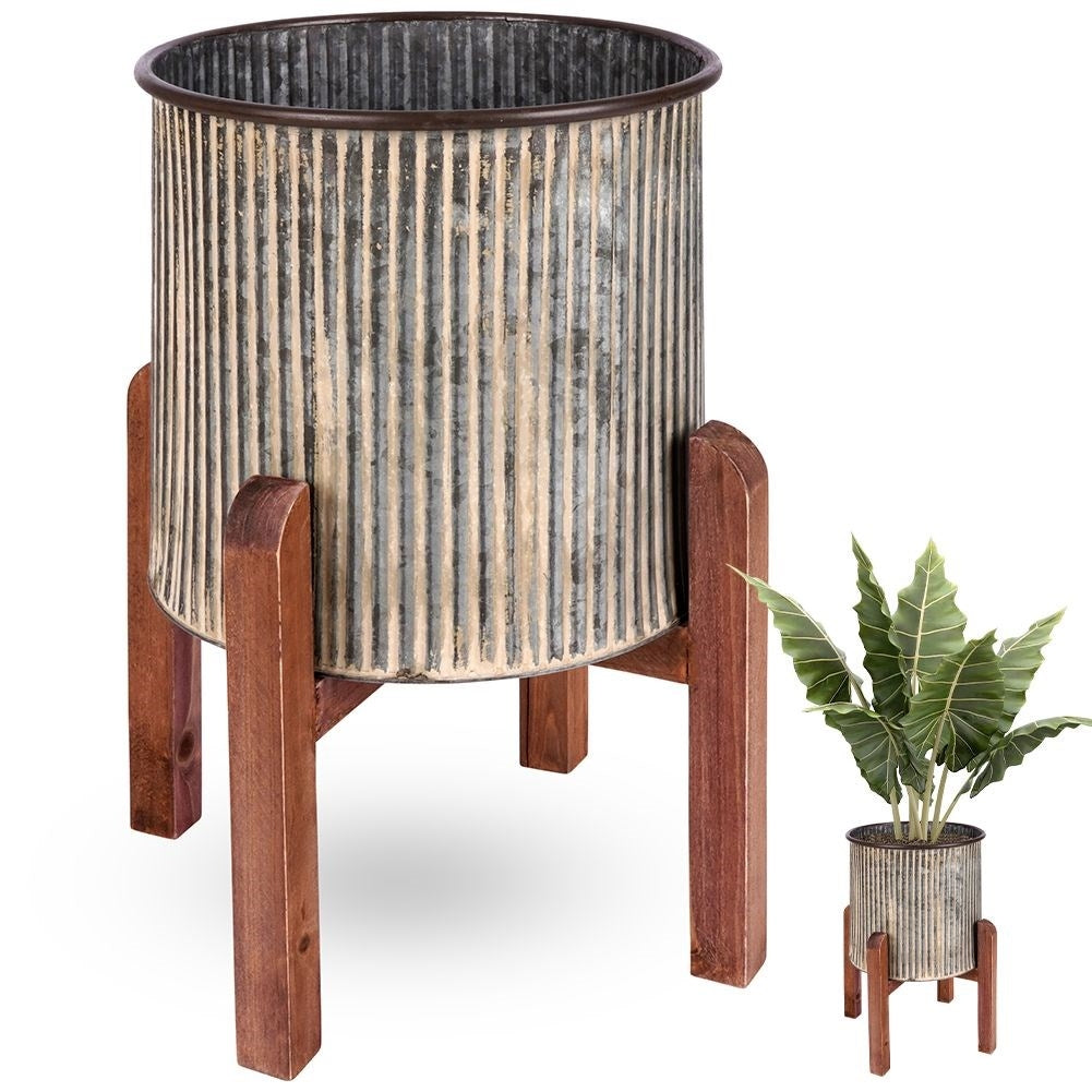 Steel flower pot with grooved surface on a wooden stand