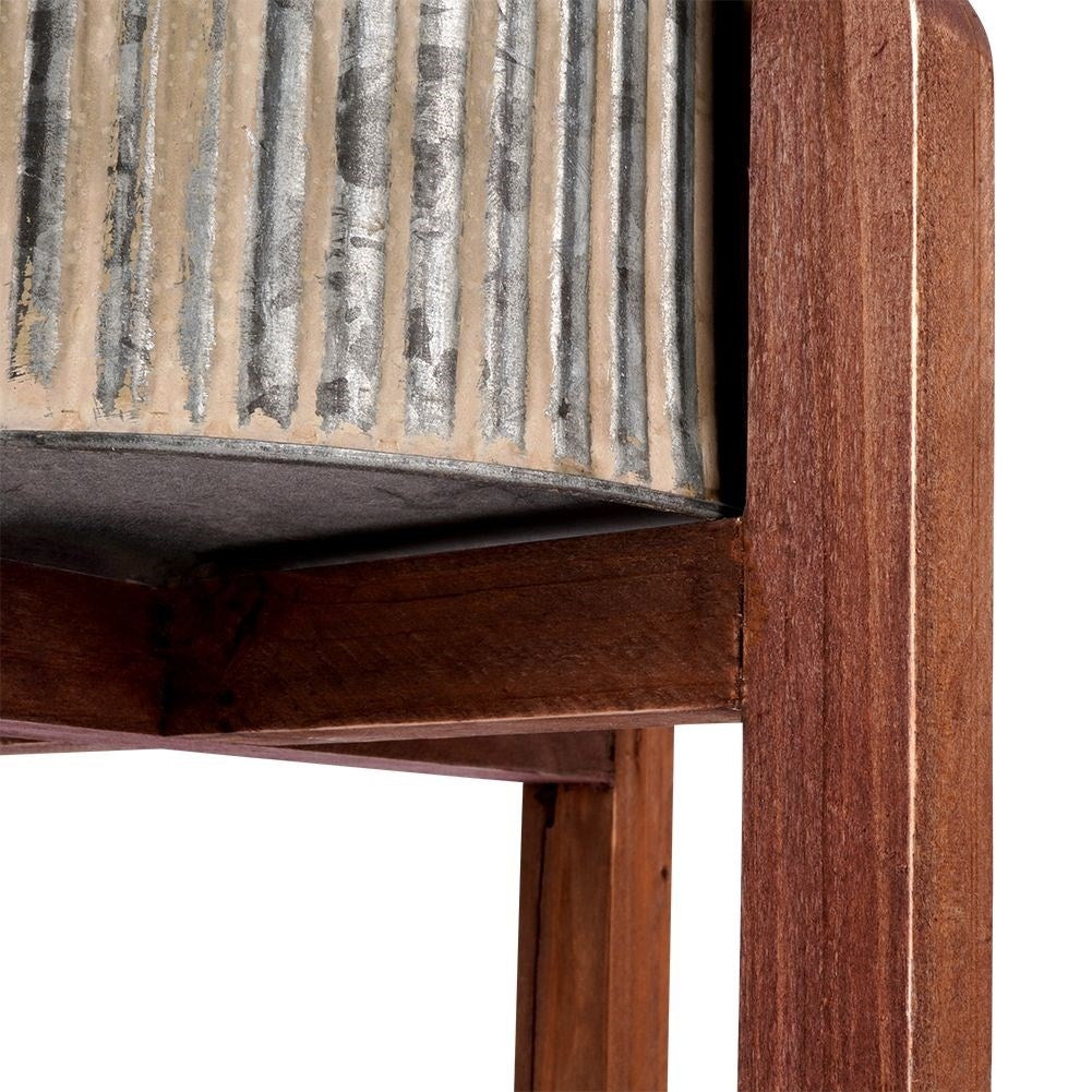 Steel flower pot with grooved surface on a wooden stand