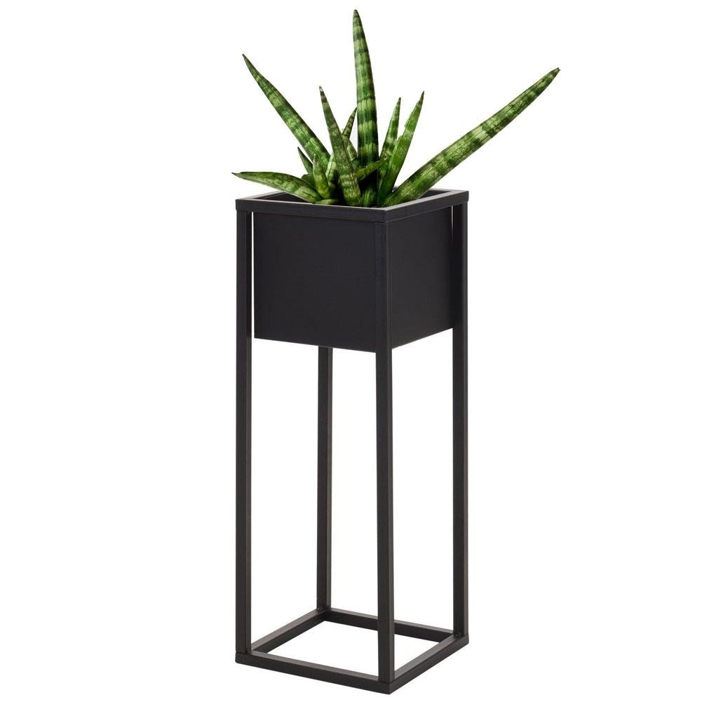 Stylish black metal flower pot on a stand